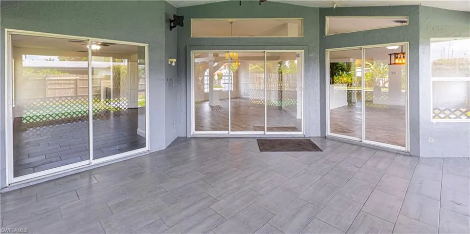 Back of property with multiple entrances into the home from the screened in patio.