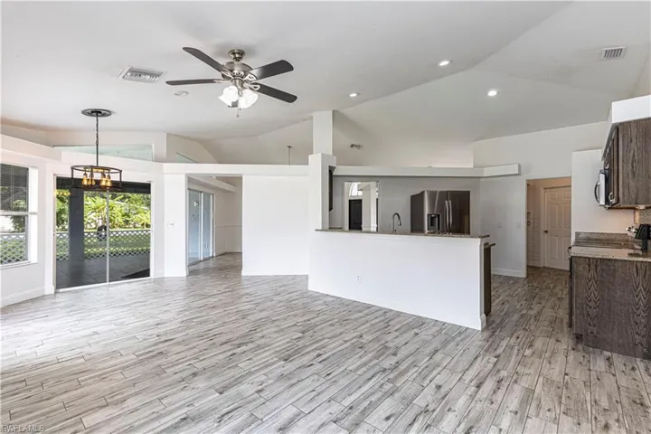 Kitchen featuring appliances with stainless steel finishes. Laundry room in the back with door to the garage for easy access.