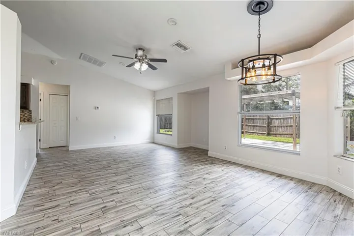 Dining area open to living room space. Kitchen on the left with bar seating. Lots of natural light.
