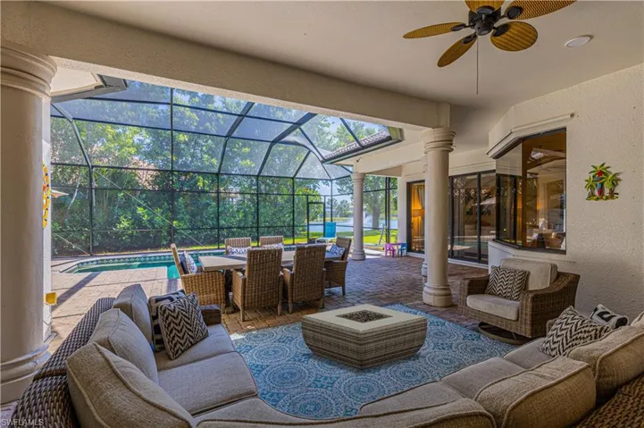 View of patio / terrace with ceiling fan, an outdoor living space, and glass enclosure