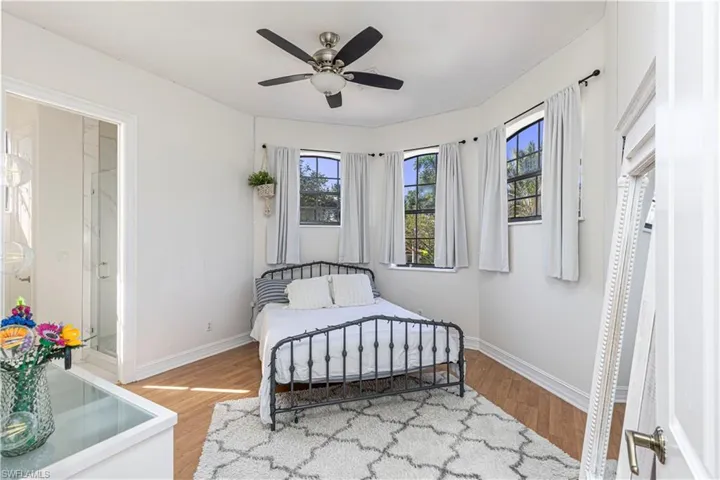 Bedroom with ceiling fan and hardwood / wood-style floors