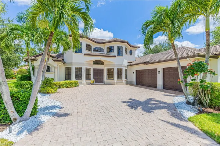 Mediterranean / spanish house with a balcony, french doors, and a garage