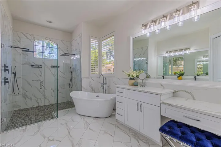 Bathroom with plenty of natural light, vanity, and tile patterned floors