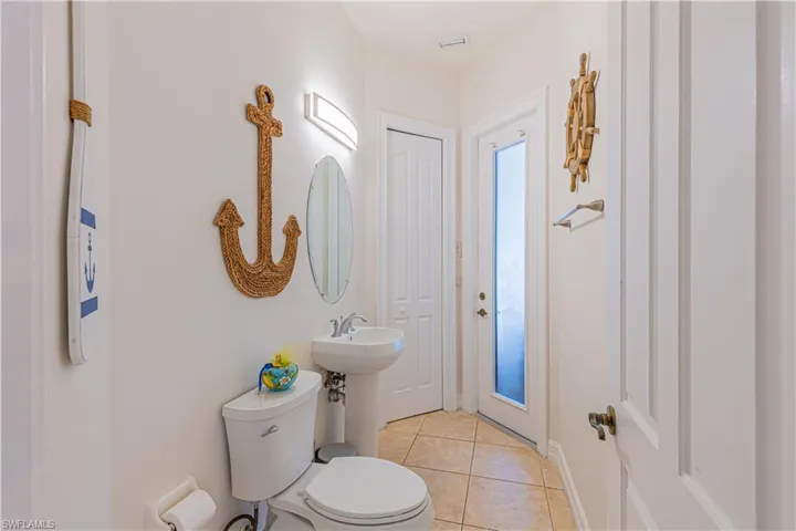 Bathroom with toilet and tile patterned flooring