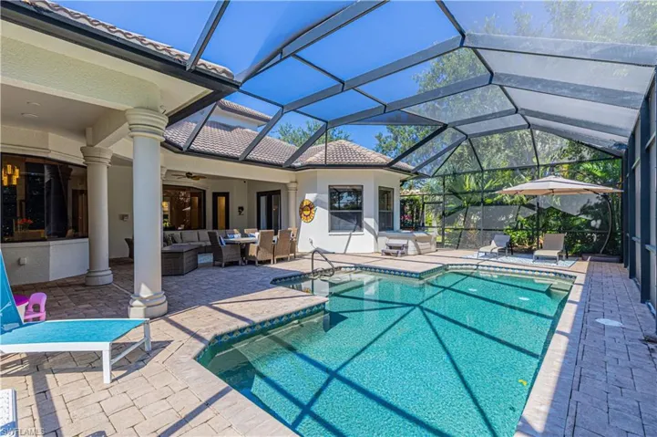 View of swimming pool with ceiling fan, a patio, an outdoor hangout area, and a lanai