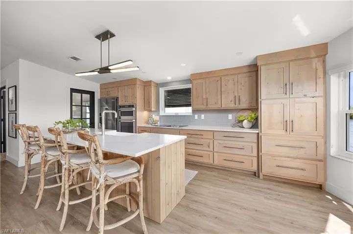 Custom solid wood soft-close cabinetry w/ quartz countertops