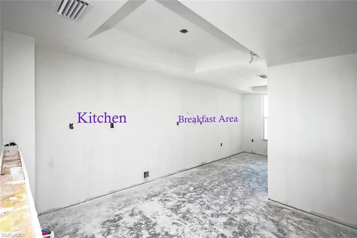 Unfurnished room featuring a tray ceiling
