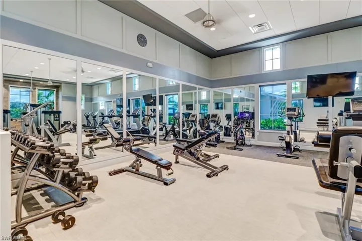 Gym with visible vents, a high ceiling, and carpet floors