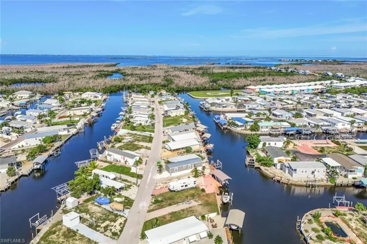 Birds eye view of property with a water view