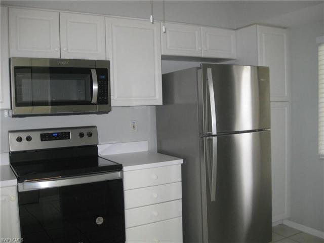 White, bright cabinets, pantry, and stainless steel appliances!