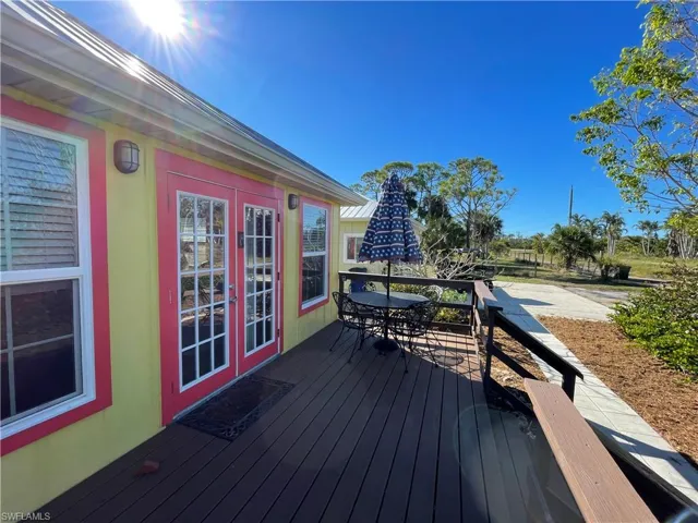 Rental cottage with deck featuring french doors and outdoor dining area