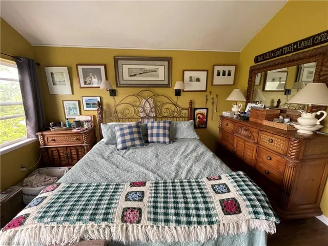 Bedroom featuring lofted ceiling