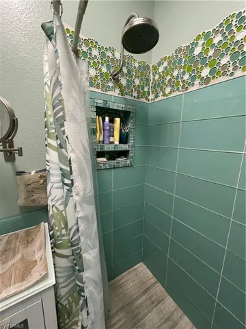 Full bathroom featuring tiled floors shower.