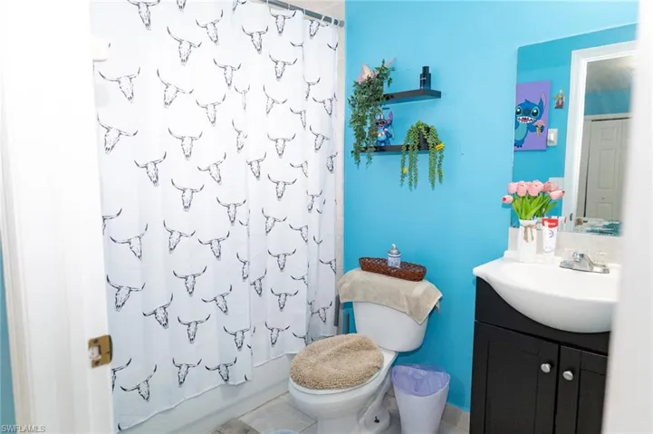 Full bath featuring vanity and shower / bath combo