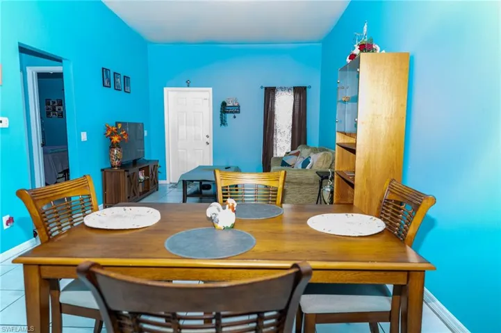 Tiled dining space featuring baseboards