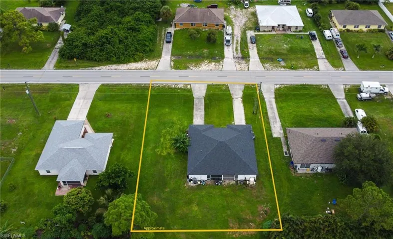 Aerial perspective of suburban area featuring property parcel outlined