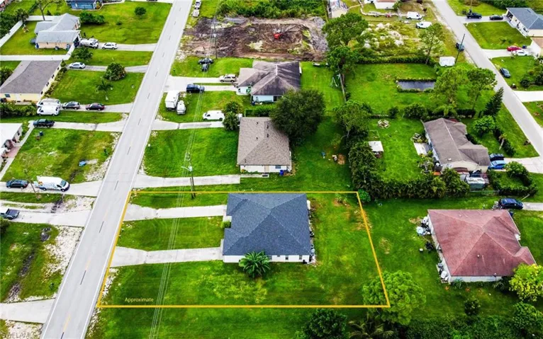 Aerial view of residential area featuring property boundaries highlighted