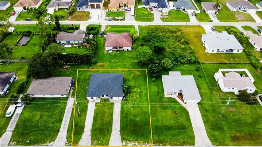 Aerial perspective of suburban area featuring property parcel outlined