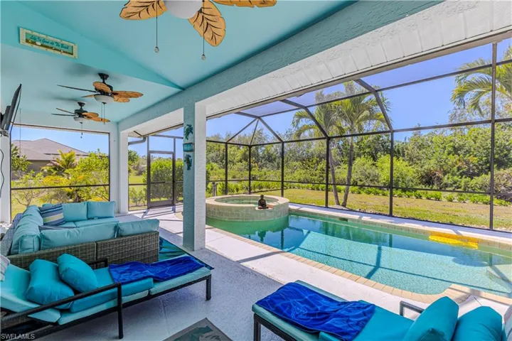 Integrated pool / spa with an outdoor hangout area, a sunroom, a lanai, and a patio