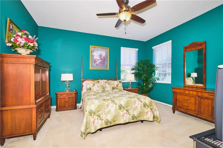 Bedroom featuring light carpet and ceiling fan
