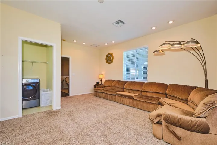 Carpeted living area featuring washer / dryer and recessed lighting