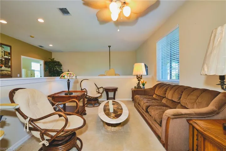 Living area with a ceiling fan and recessed lighting