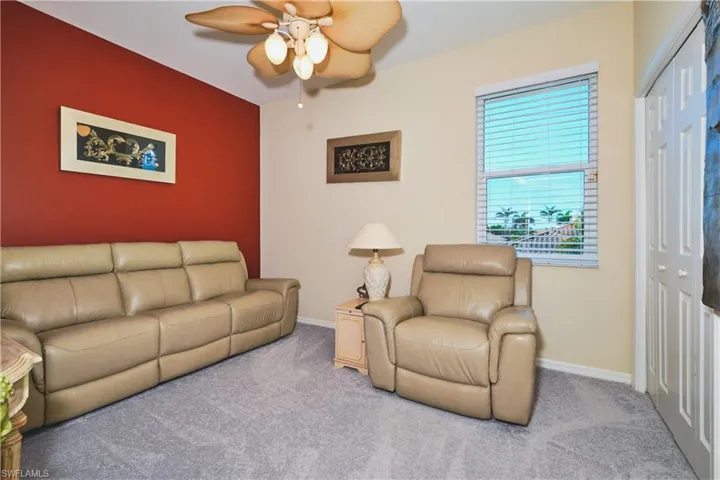 Living room with carpet floors and a ceiling fan