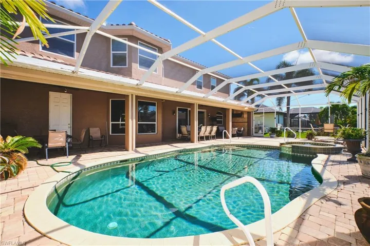 View of pool with a sunroom, a patio, glass enclosure, and a pool with connected hot tub