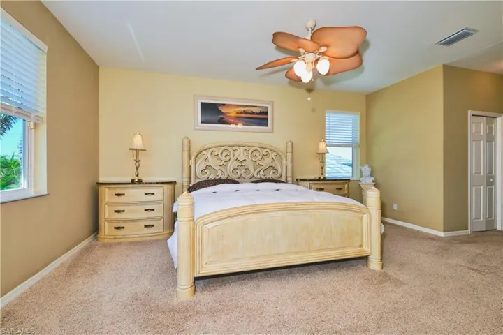 Bedroom with light carpet and ceiling fan