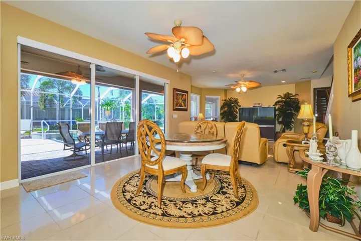 Dining area featuring light tile patterned flooring and a sunroom