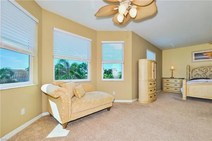 Carpeted bedroom with baseboards and ceiling fan