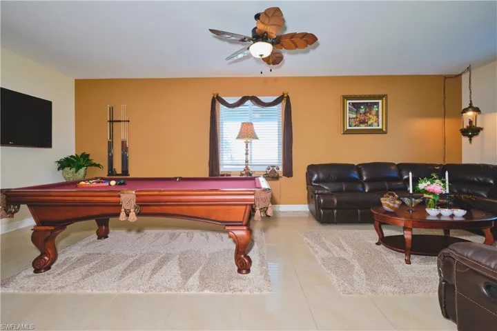 Recreation room with billiards table, tile patterned flooring, and ceiling fan