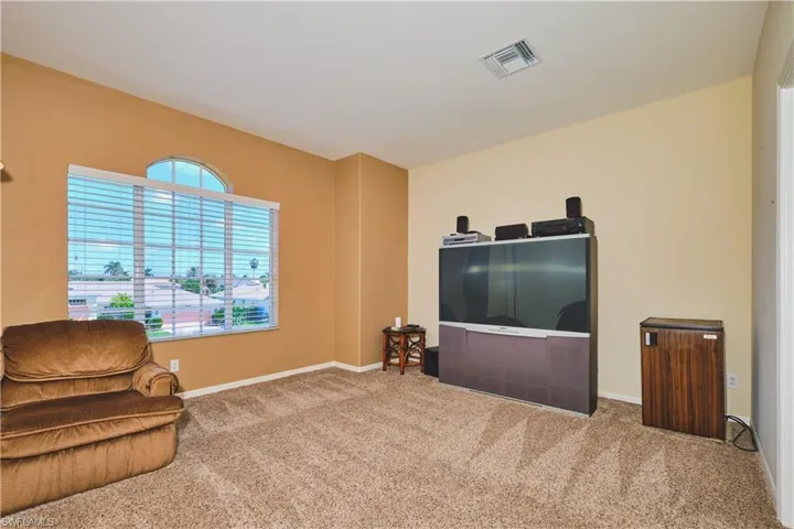 Sitting room with carpet floors and baseboards
