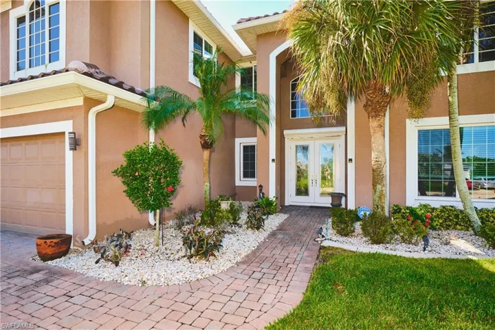 Property entrance with french doors and stucco siding