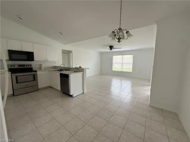Open-concept kitchen and living area featuring tile flooring throughout