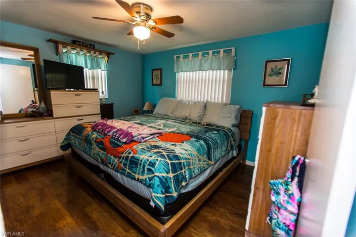 Bedroom featuring dark hardwood / wood-style flooring and ceiling fan