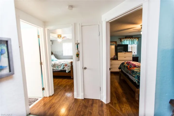 Hallway with dark hardwood / wood-style flooring
