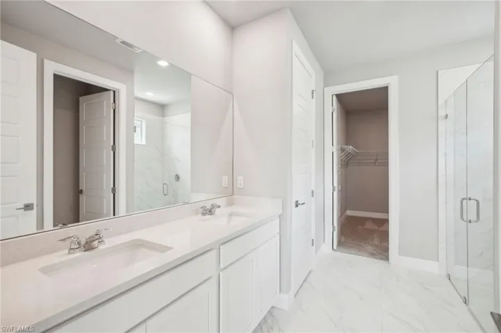 Bathroom with vanity and an enclosed shower