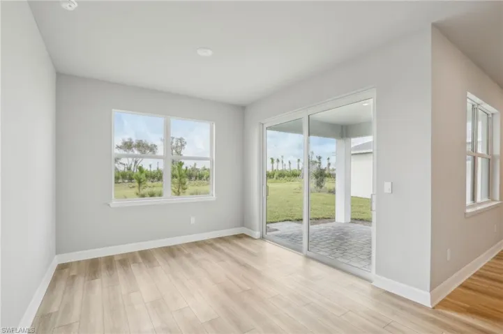 Empty room featuring light hardwood / wood-style floors and a wealth of natural light