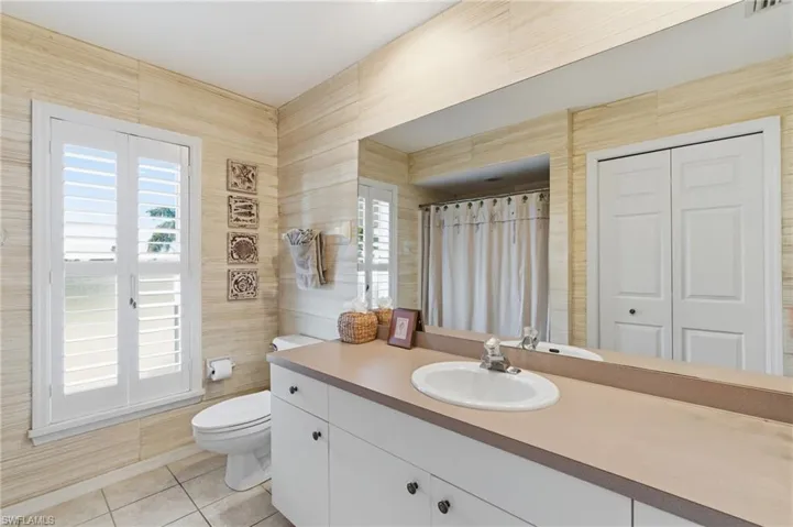 Sizable vanity,linen closet & tub in guest bathroom