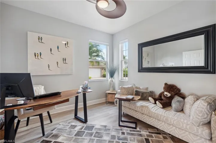 Home office with light hardwood / wood-style flooring