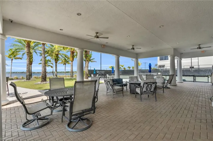 View of patio with ceiling fan, a water view, and an outdoor hangout area