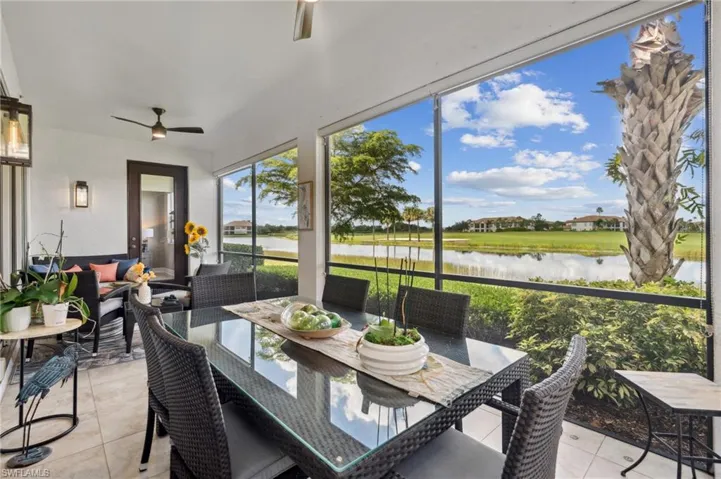Sunroom featuring a water view and ceiling fan