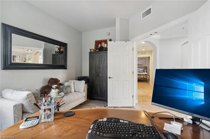 Living room with light hardwood / wood-style floors and ornamental molding