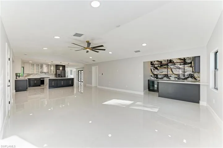 Unfurnished living room featuring recessed lighting, vaulted ceiling, a ceiling fan, and light tile patterned flooring