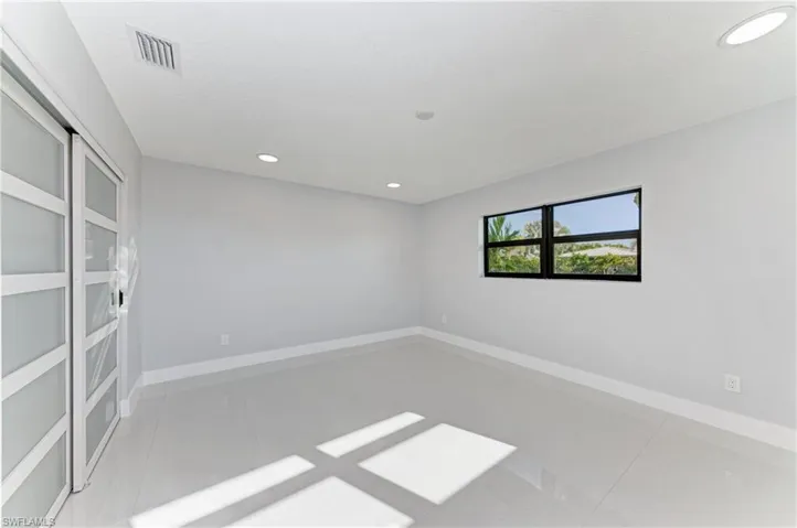 Unfurnished room featuring recessed lighting and baseboards