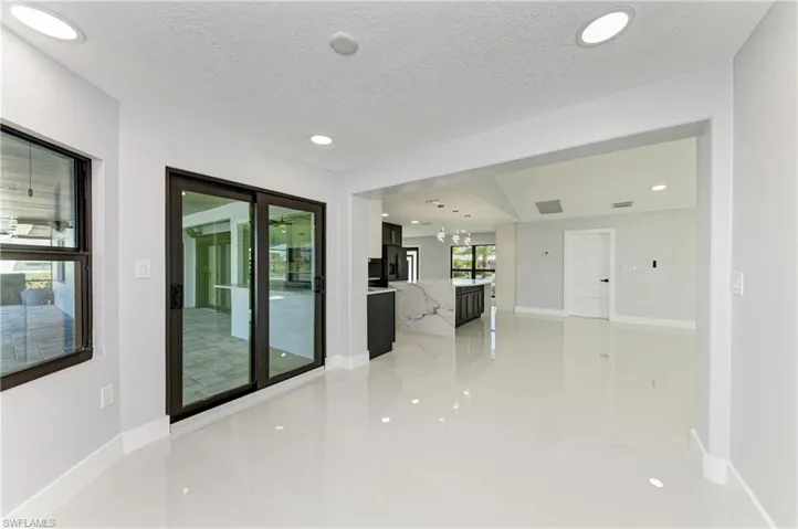 Unfurnished room featuring a chandelier, recessed lighting, and a textured ceiling