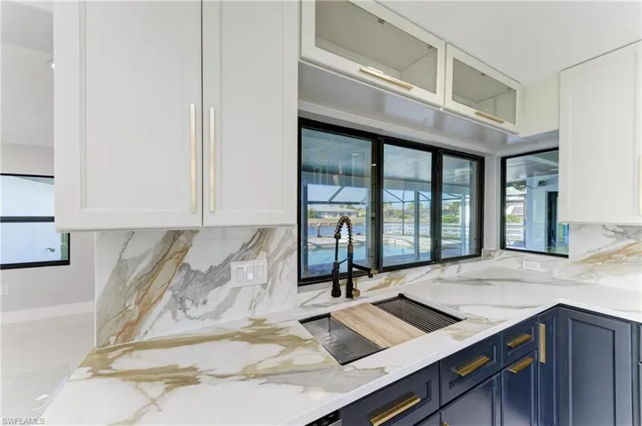 Kitchen featuring light stone countertops and plenty of natural light