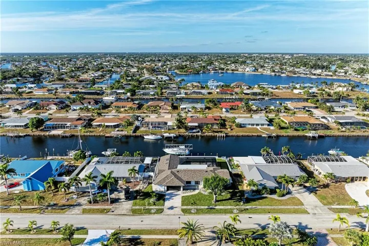 Aerial perspective of suburban area featuring a large body of water