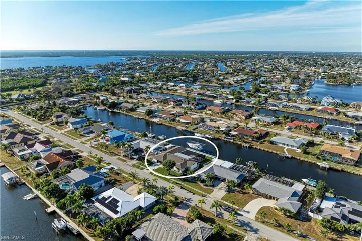 Aerial view of residential area featuring a nearby body of water